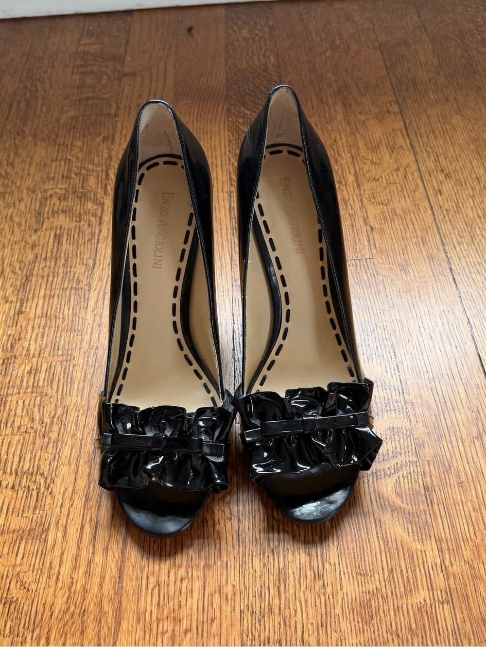 Black open-toed heels with ruffle and bow detail